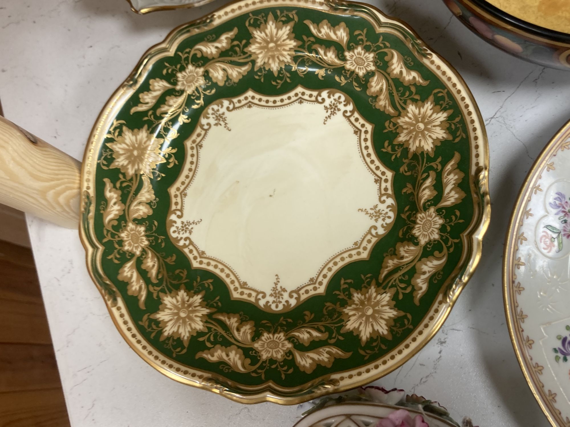 A Continental porcelain shaped oval posy basket encrusted with carnations and sundry ceramics,